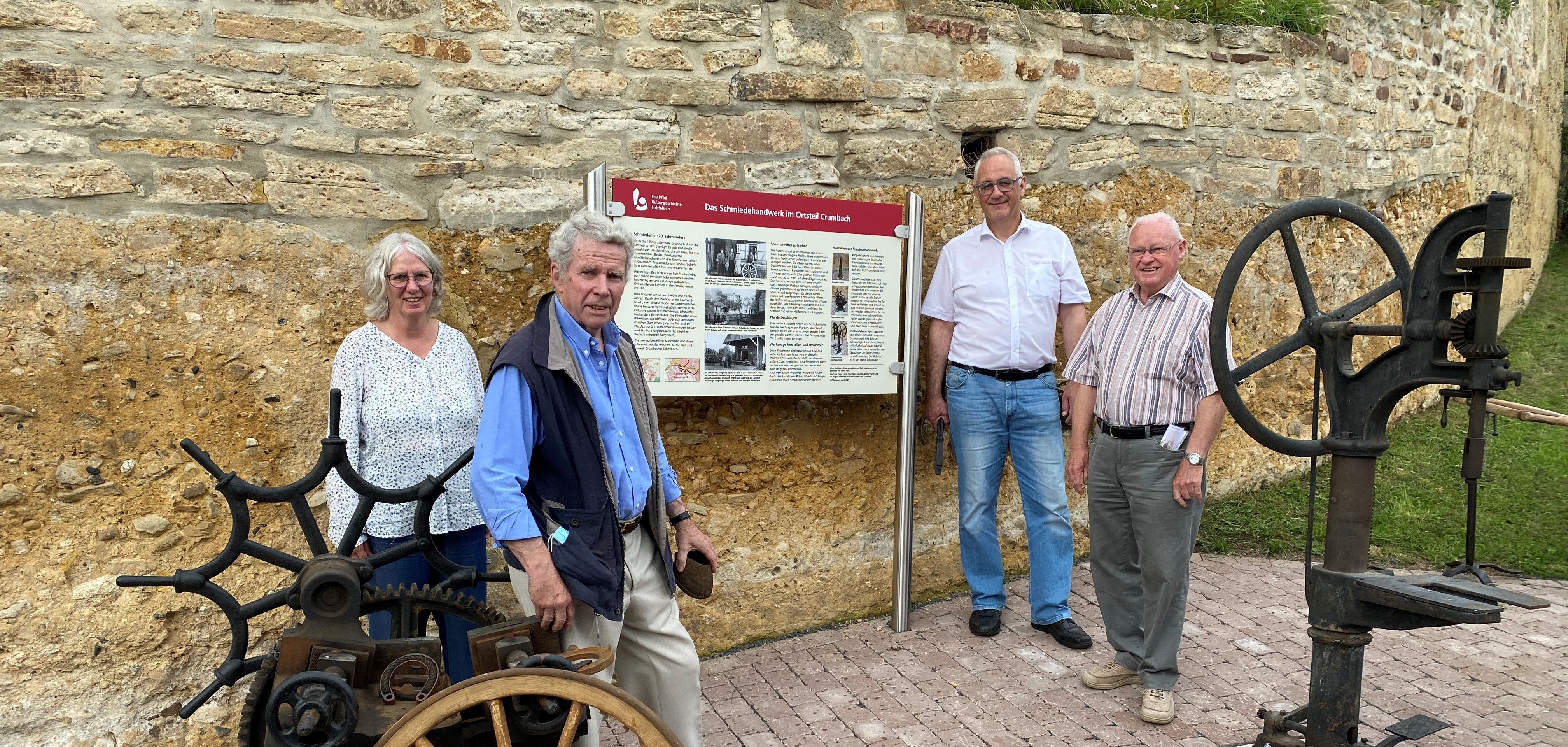 Die neue Eco-Pfad-Tafel am Fahrweg unterhalb der Kirche Crumbach. Bürgermeister Uwe Jäger (2.v.r.) bedankte sich bei Horst Fehr (2.v.l.) für die Stiftung der Schmiedewerkzeuge und bei Dr. Angela Pitzschke und Walter Pfaffe (r.) für die Zusammenstellung der Texte.