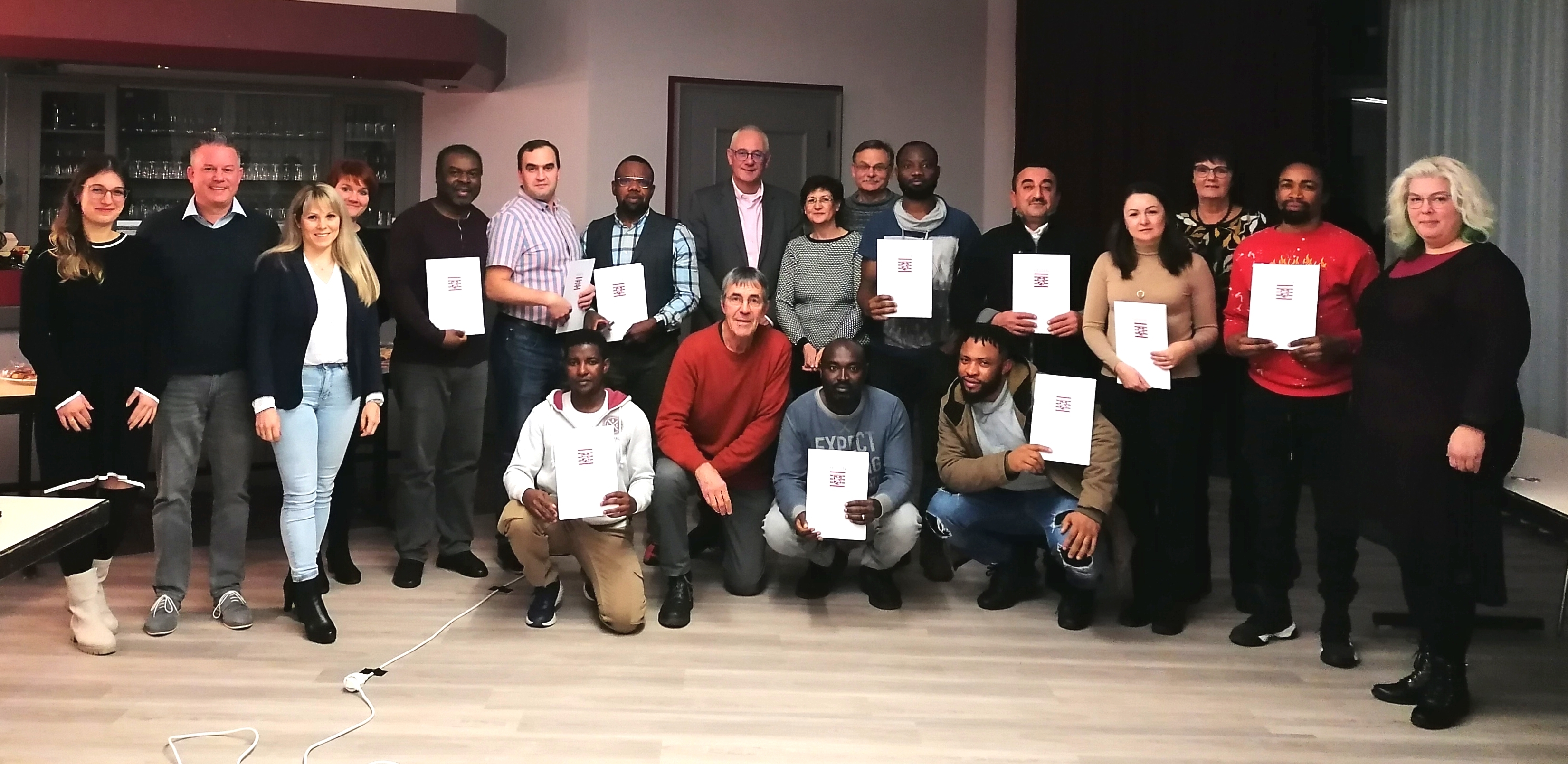 Die frischgebackenen Einbürgerungslotsinnen und –lotsen erhielten am 09.12.2022 ihr Zertifikat.   Absolventinnen und Absolventen v.l.n.r., hintere Reihe: Balogun Abhulimen Momodu, Andrei Rau, Friday Aigbomian, Götz Schilling, Kelvin Ojugo, Alan Osman, Jana Hense, Emmanuel Isidahomen; vordere Reihe: Ali Osman, Stephen Awung und Godwin Amos.  Es gratulierten v.l.n.r. Susanna Alejunas (Bürgerservice), Thorsten Bürgel (Fachbereichsleiter 2), Christina Ruck (Organisation), Jennifer Adrian (Dozentin), Uwe Jäger (Bürgermeister), Bernd Hirschfelder (Dozent), Andrea Kather (Bürgerservice) Sylvia Schmitz (Bürgerservice) und Diana Valent (Bürgerservice). 