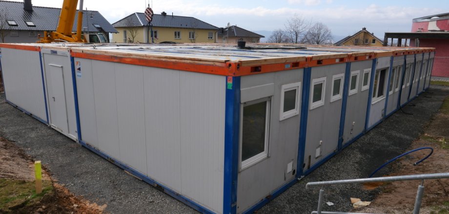 Containeranlage weiß blau mit Fenstern.