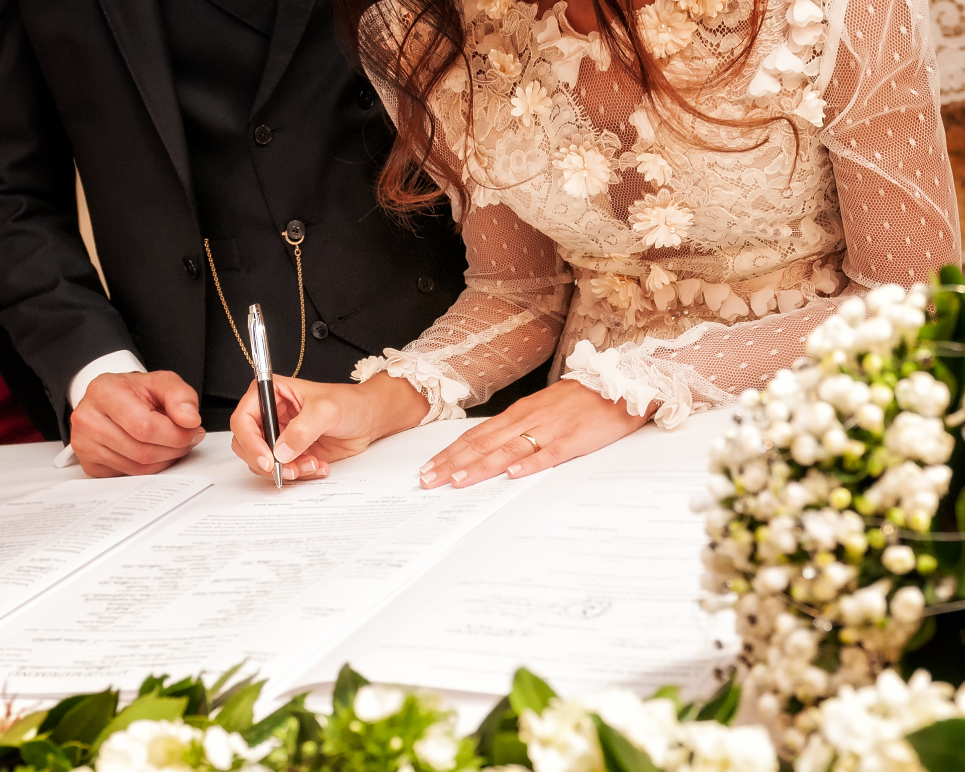 Hands signing during the wedding