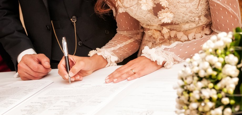 Hands signing during the wedding