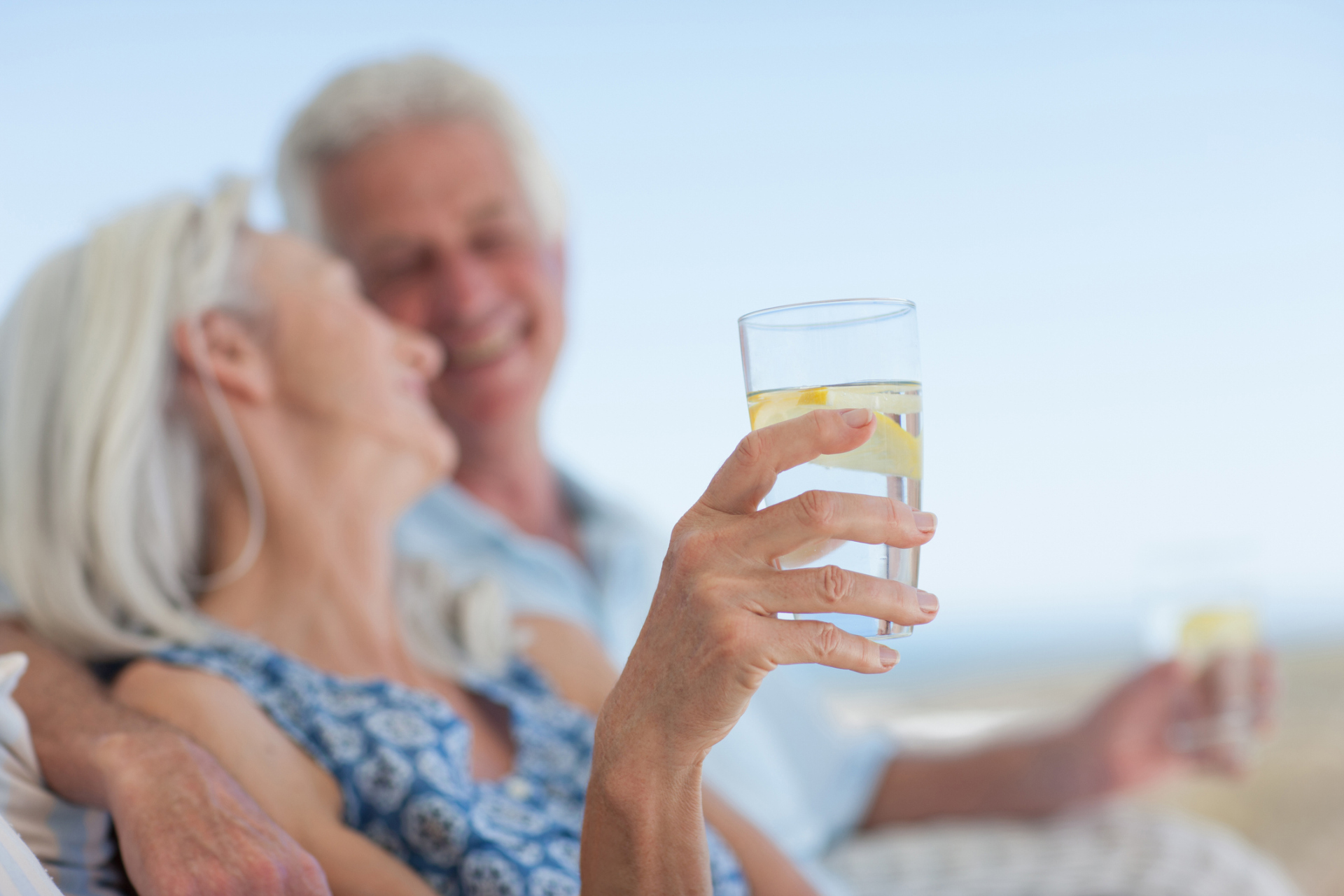 Senior couple drinking water on beach