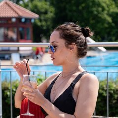 Frau trinkt Kaffee im Freibad Lohfelden.