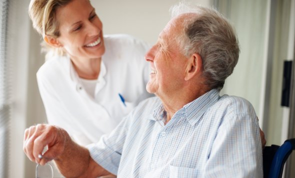 Elderly man speaking to a nurse