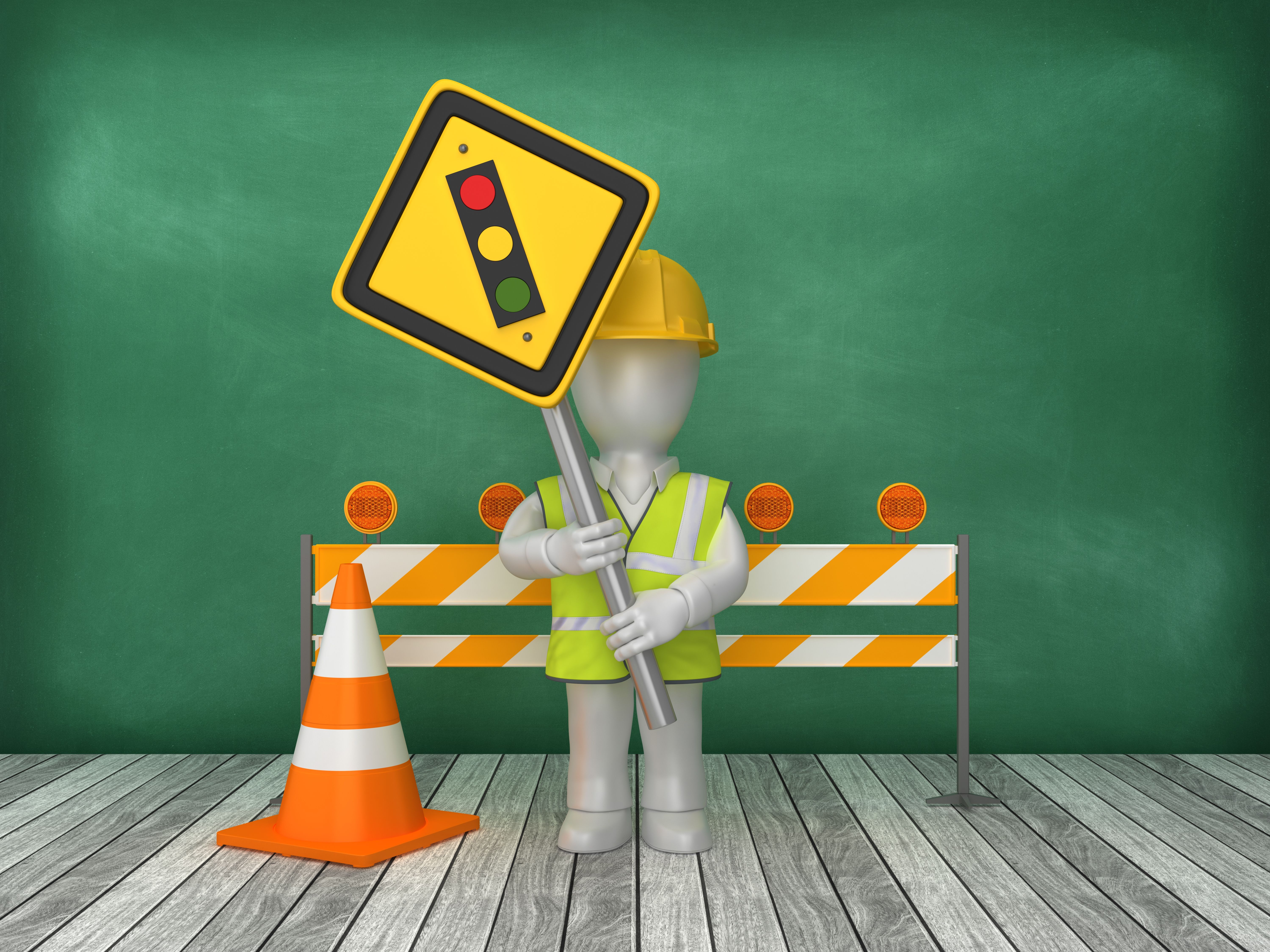 Auf dem Foto sieht man ein Legomännchen mit einem Schild in der Hand, auf dem eine Ampel abgebildet ist, hinter vor einer rot-weißen Straßensperre.