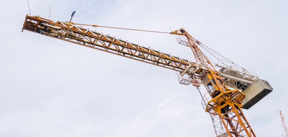 Tower Crane At Construction Site Outdoor. City Urban Development An Crane Do Lifting To Built To Infrastructure.