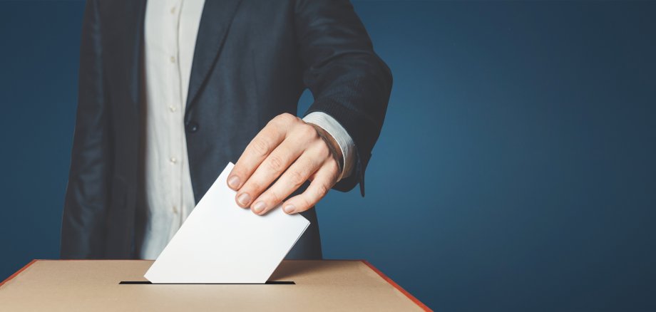 Man Voiter Putting Ballot Into Voting box. Democracy Freedom Concept