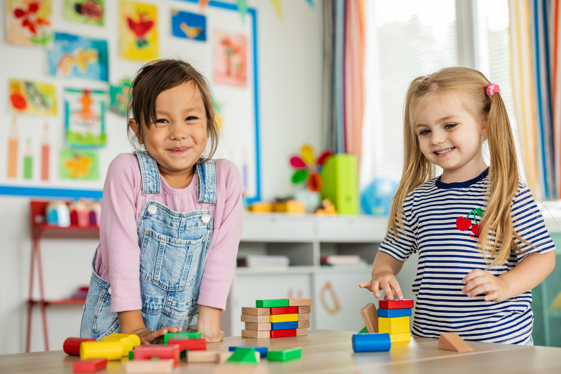 Happy children are sitting on the floor in the kindergarten